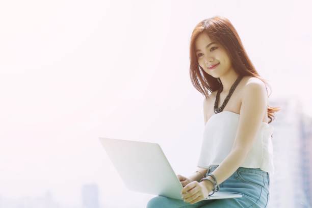 istock Businesswoman on break. or college student girl using her tablet computer Sit on a lifestyle chair. / concept product presenter. 1133366142