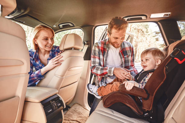 travel is like an endless university. you never stop learning. parents playing with their kid inside a car. family road trip - travel baby people traveling family imagens e fotografias de stock
