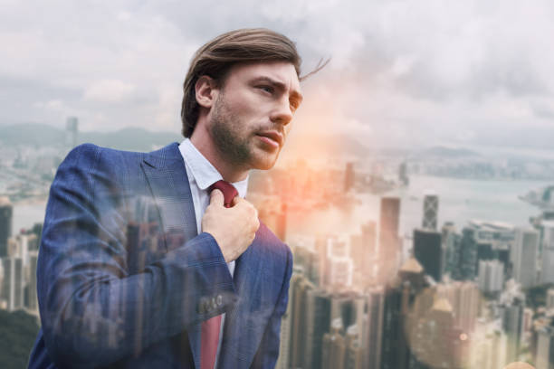 istock Busy morning. Attractive business expert adjusting his necktie while standing outdoors with cityscape on the background 1133374610