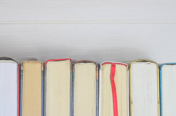 istock Lots of colourful thick open books stand on a white background 1133374909