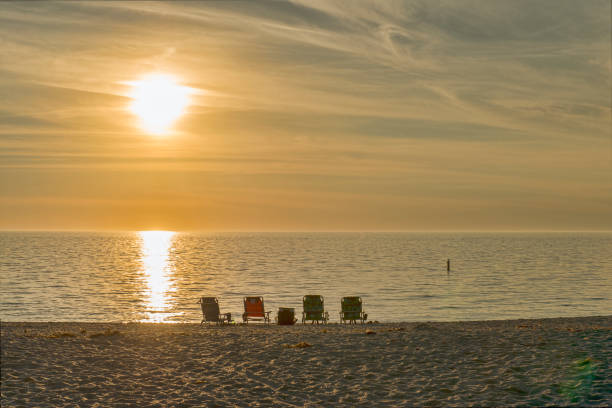 istock Chairs on the Beach at Sunset 1133379615