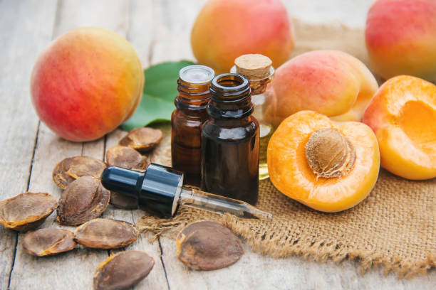 istock apricot oil in a small jar. selective focus. 1133382907