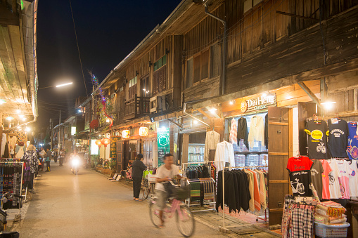 old wood houses and the evening market in the old town of Chiang Khan in Isan in north east Thailand