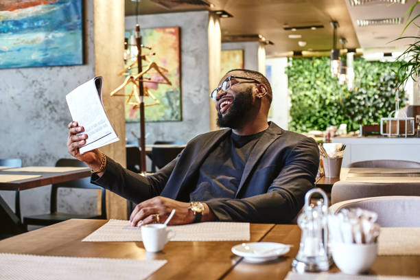 istock It's a fascinating article! African american businessman is reading a newspaper while resting in the cafe 1133385424