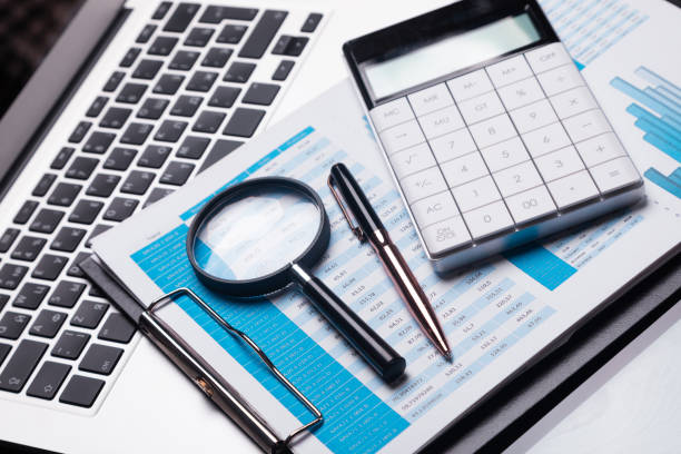 istock Office workplace with magnifier and stationery 1133385603