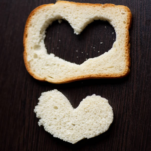 hearts carved from a piece of bread on a wooden table