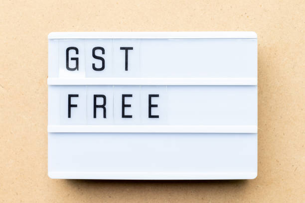 istock White lightbox with word GST (Abbreviation of Goods and Service Tax) free on wood background 1133388847