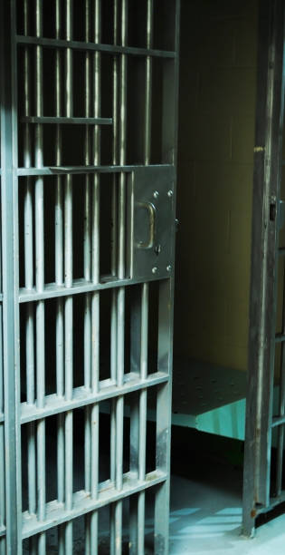 istock An open jail cell door with an dark interior 1133389024
