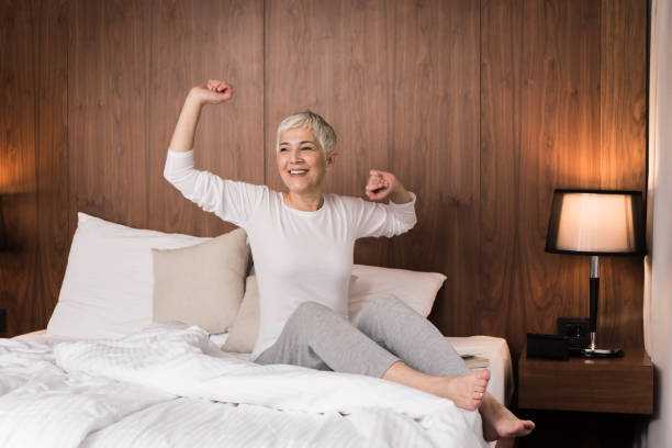 Woman stretching in her bed