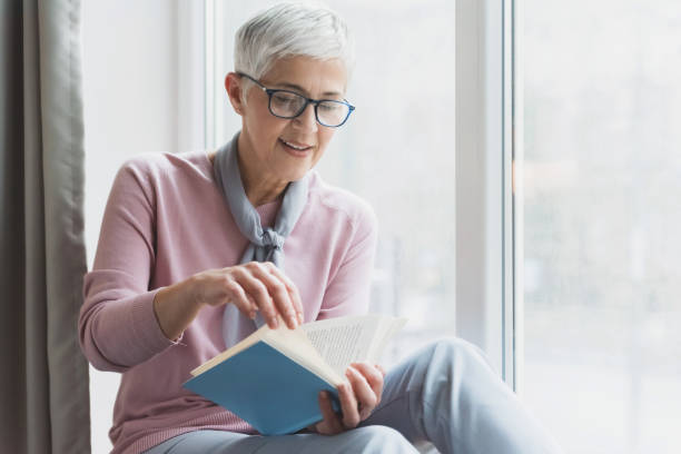 istock Mature woman reading book 1133389645