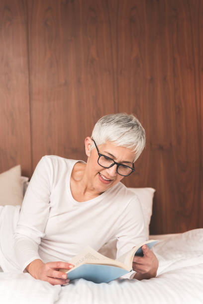 istock Mature woman reading book 1133389650