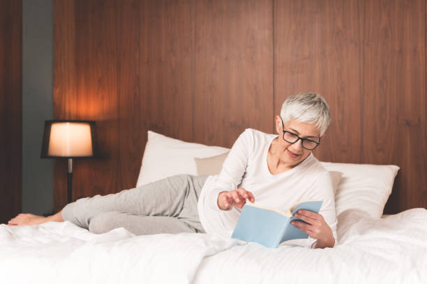 istock Mature woman reading book 1133389653