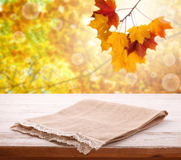 istock Tableclothe on wooden desk. Autumn background. Top view mock up. Selective focus. 1133390454