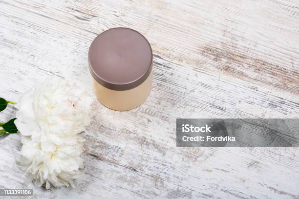 Body And Hair Cosmetics Peonies On Wooden Background Stock Photo - Download Image Now