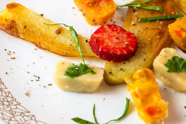 Roasted pieces and vegetable pieces, closeup.
