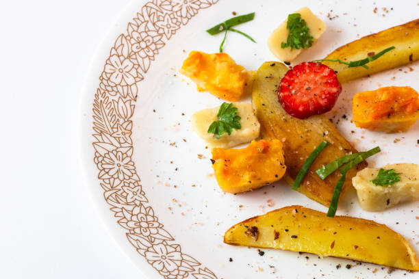 Roasted vegetable pieces and puree on plate.