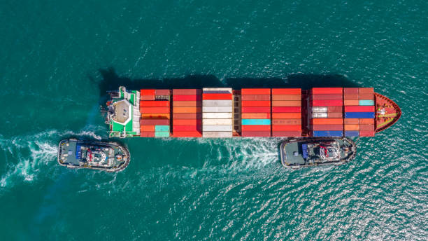 istock Container ship in export and import business logistics and transportation. Cargo and container box shipping to harbor by crane. Water transport International. Aerial view and top view. 1133392284
