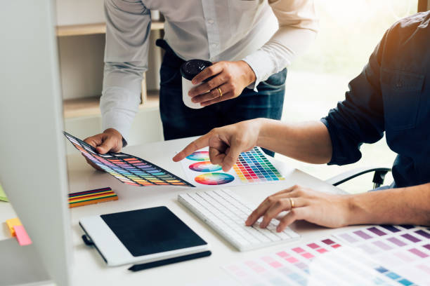 istock Co-worker graphic designer working with partnership choosing color on desk in modern office. 1133392774