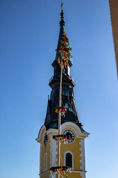 istock View of a church tower with maypole 1133394554