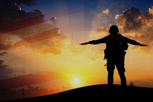Double exposure Silhouette of Soldier on the United States flag in sunset for Veterans Day is an official USA public holiday background,copy space
