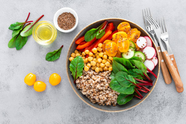 istock Vegetarian Buddha bowl with boiled buckwheat, chickpea and vegetables, top view 1133394827
