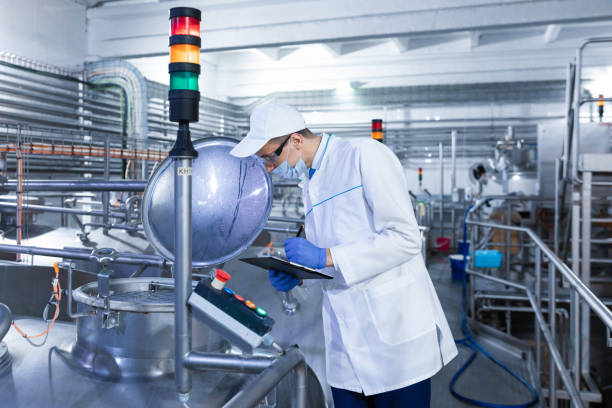 istock man in a white robe and mask makes notes standing in the shop 1133394835