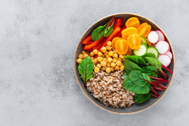 istock Vegetarian Buddha bowl with boiled buckwheat, chickpea and vegetables, top view 1133394908
