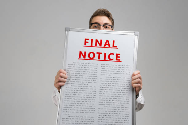 istock Young man keeps in front of him final notice isolated on light background 1133396087