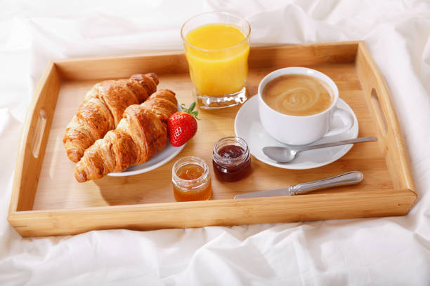 istock breakfast tray in bed : coffee, croissants and juice 1133397696