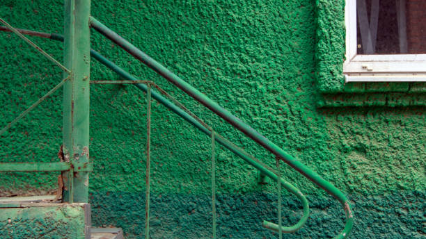 istock Old green wall with steel stairway 1133397877