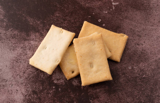 istock Cheese flavor crostini crackers on a maroon counter top. 1133400632