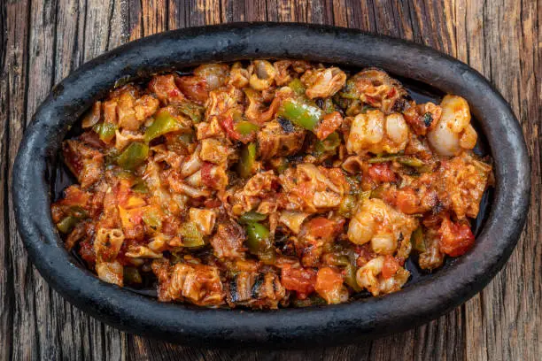Photo of Turkish Street Food Kokorec made with sheep bowel cooked in wood fired oven. Kokorec kebab casserole.