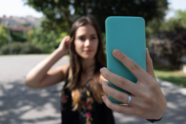 istock Girl taking selfie with smartphone blurred 1133402684