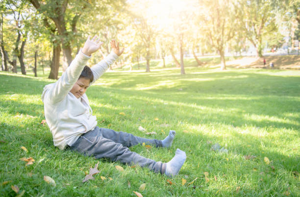 istock Fat boy stretch oneself in park, 1133402779