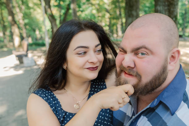 istock Two people in love sit on a bench in the park 1133404410