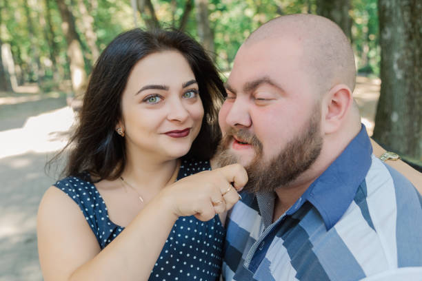istock Two people in love sit on a bench in the park 1133404437