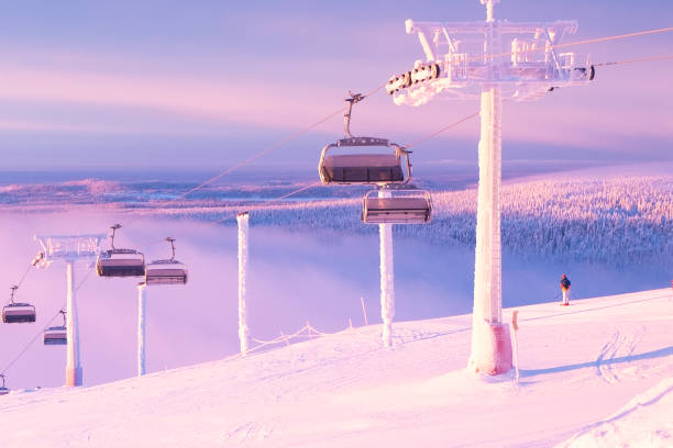 Ski resort in Lapland. Winter morning at the top of Ruka mountain Skier preparing for the descent Morning at the top of the ski resort. Ruka Finland Lapland ski resort. The skier is preparing to descend. красота stock pictures, royalty-free photos & images