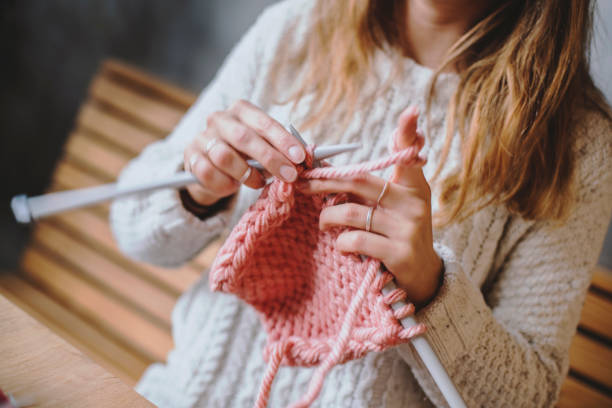 istock Close up on woman's hands knitting 1133404746
