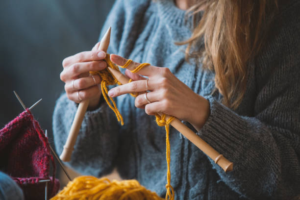 istock Close up on woman's hands knitting 1133404747