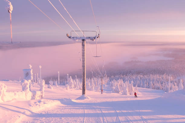 Ski slope in the rays of the rising sun. Skier slides down the mountain. Morning in Lapland. The ski resort of Ruka Kuusamo. Morning on the mountain. Finland Lapland. красота stock pictures, royalty-free photos & images