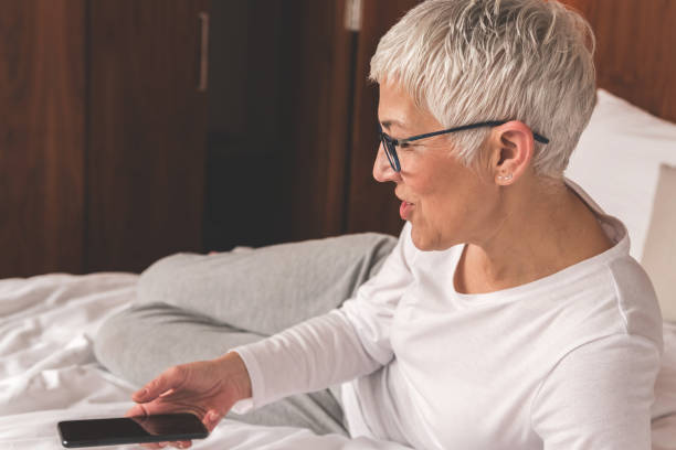 istock Woman using app on her mobile phone 1133407125