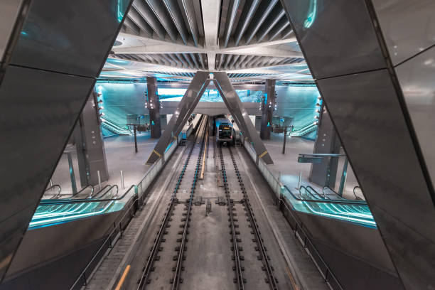Bilbao Metro platform and exit sign. - A view of a platform inside a Bilbao Metro station, featuring a staircase leading to the exit, with Irteera/Salida on the sign.