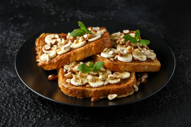 istock French cinnamon toast with banana, nuts and hazelnut, honey. 1133407629