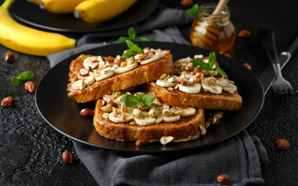 istock French cinnamon toast with banana, nuts and hazelnut, honey. 1133407736