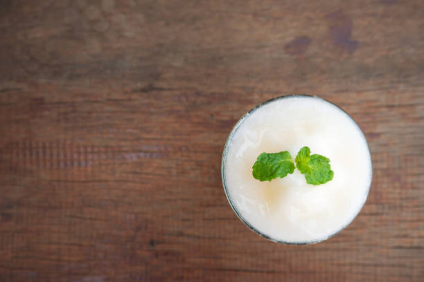 istock Melon smoothie on wooden background. Top view with copy space. 1133408929