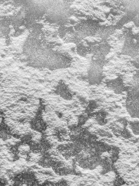 Ice and snow texture, winter background: Frosty pattern on ice covered with crust snow Abstract winter frosty texture background: Snow and hoarfrost closeup texture on the frozen ice under crud snow with copyspace for design crud stock pictures, royalty-free photos & images