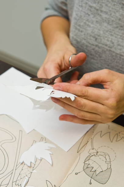 istock Woman doing paper cutouts 1133410613