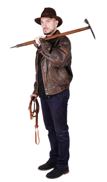 istock Adventurer explorer is holding pickax and whip isolated on white background 1133412024