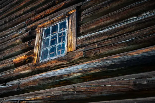 Old wood log background with cracks and lines. Windows on wall of house.