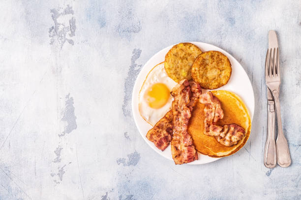 istock Healthy Full American Breakfast with Eggs Bacon Pancakes and Latkes 1133418694